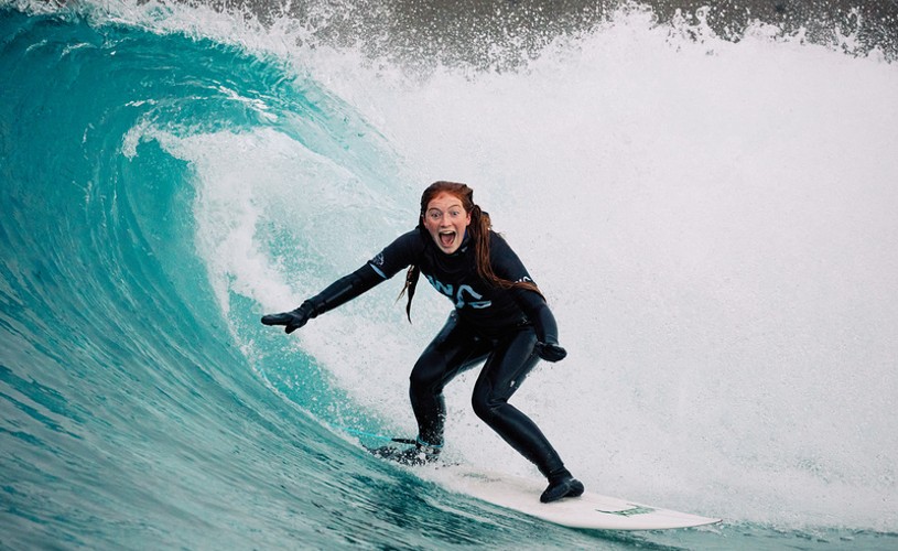Woman surfing in the barrel at The Wave